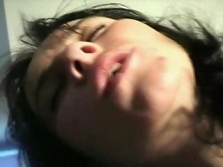 Young woman with black hair gives oral pleasure to big dog
